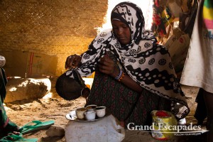 Afar young lady serving traditional Ethiopian coffee, village of Hamed Ale, Danakil Depression