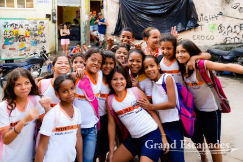 Rocinha, home to 180.000 people, is the biggest favela in Rio de Janeiro, Brazil - Kids going out of school and posing happily for the photo ... Looking at the result on the display of the digital camera was the cause of some excitment!