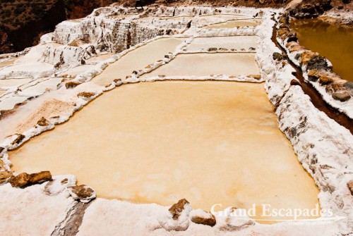 The salt pans near Maras are are fed by a little salty river that emerges from the mountain, near Cuzco, the Sacred Valley, Peru