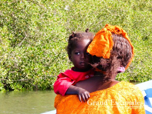 On the Casamance river, giving a lift to a woman with her little daughter ...