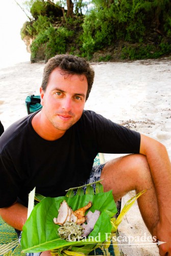 Gilles enjoying a traditional "Umu" on the beach, Atiu Island, Cook Islands